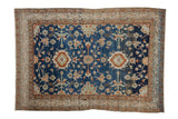 Distressed vintage Hamadan rug with a floral medallion on a sapphire blue field with rust and ivory accents.