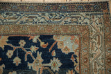 Worn texture and visible knot heads on a distressed Persian rug corner with rust and dusty blue floral borders.
