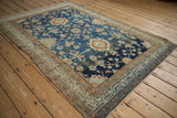 Angled view of the vintage Hamadan rug's distressed pile, with heavy abrashes over the blue floral pattern.