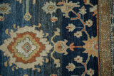 Worn pile on a distressed Hamadan rug showing sapphire blue and burnt orange floral details.