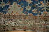 Even wear across the hand-knotted pile on the border of a distressed vintage Hamadan rug.