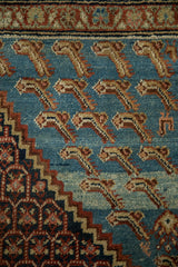 Stylized Mahi-mahi design elements and a stepped corner spandrel on an antique distressed Persian rug.
