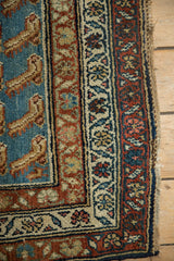 Layered borders and stylized Mahi-mahi motifs on the corner of an antique Persian Hamadan rug.