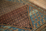 An antique Hamadan rug corner showing stylized Mahi-mahi motifs on an aquatic blue field.