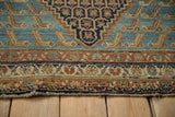 Antique Hamadan corner spandrel with stylized Mahi-mahi motifs on an ocean blue field.