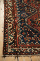 Serrated leaf border and hand-knotted pile on an antique Persian Afshar rug corner.