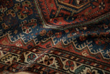 Softly folded antique Afshar rug displaying its dense pile and serrated leaf border design.