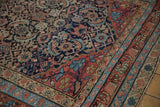 Corner view of an antique Malayer carpet highlighting the detailed Herati motif and rich color abrashes.