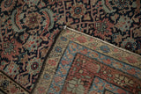 The hand-knotted reverse and Herati pattern pile of an antique Malayer carpet.