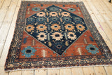 Vintage Persian Mehriban rug's bottom fringe and geometric border in madder root, navy.