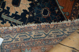 Hand-knotted Mehriban rug foundation, displaying geometric weaving in navy, rust, and beige.