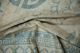 Soft folds showing the high sheen and softened texture of a distressed antique Peking carpet.