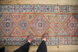 Antique Northwest Persian rug showing camel, pale ruby, and sky blue geometric medallions with stepped designs.