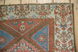 Fringed corner of antique Northwest Persian rug, with henna plant border and wave inner motif.