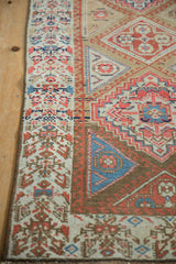 Antique Northwest Persian rug detail showing henna plant border, running wave, and geometric motifs.