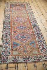 Antique Northwest Persian rug's Henna plant main border, with aged pale red, beige, and navy patterns.