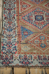 Antique Northwest Persian rug's geometric Henna plant border, running wave inner motif, and stepped field pattern.