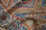 Aged texture and geometric stepped patterns in camel, coral, and blue on this antique Northwest Persian rug.