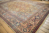 Vintage Mahal carpet detail: saffron yellow field with diamond spandrels and rich Samovar vine border.
