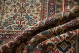 Textured brick red Samovar vine border and ivory field with germinating plants on a Mahal rug.