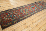 Heriz runner with geometric medallions and blossoms in cherry red, sky blue, emerald green.