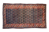 Vintage Kurdish rug, henna plant motif on navy blue, rainbow abrash, red pawn border.
