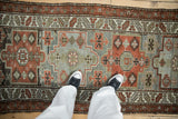 Hand-knotted vintage Malayer runner with distressed geometric pattern in rust and gray.