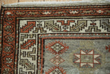 Vintage Malayer rug corner, featuring serrated leaf border and oxidized silver field.