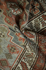 Distressed Malayer rug with rust, silver, brown diamond guls and serrated leaf border.