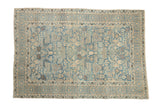 Vintage distressed Tabriz rug with an allover geometric pattern of floral blossoms in powder blue, beige, and coffee brown.