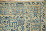 Hand-knotted pile and floral arabesque border of a vintage Tabriz rug in blue and sand tones.