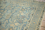 Distressed texture and geometric floral patterns in powder blue, sand, and coffee brown tones.