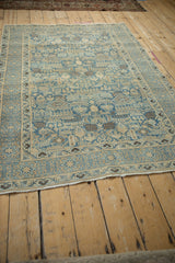 Corner view of a vintage Tabriz rug showing the secured side selvage and geometric border.