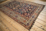 An angled perspective of a fine antique Qashqai carpet, highlighting its highly detailed geometric composition.