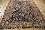 Angled view of a fine Qashqai carpet with intricate tribal motifs and multi-layered borders.