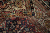 Fine weave and even wear visible on the intricate borders of an antique Qashqai carpet.
