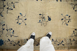 Antique Peking rug, ivory field with bouquet corner spandrels and blue vine border.