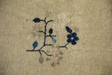 Antique Peking rug detail: cobalt and sky blue floral motif on an ivory field.