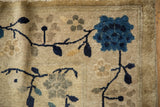 Antique Peking rug: bold cobalt blue blossom, dark vines, and pale time-softened flowers.