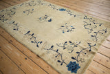 Antique Chinese Peking rug corner with cobalt blue bouquet and meandering vine border.