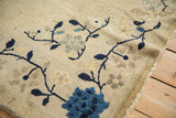 Antique Chinese Peking rug: cobalt blue meandering vines with soft floral blossoms on ivory.