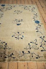 Antique Peking rug's light fringe and cobalt blue vine blossom border.