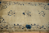 Antique Peking rug's main border with cobalt blue blossoms and meandering vines.
