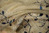 Textural close-up of the antique Chinese Peking rug's beige pile with cobalt blue vines.