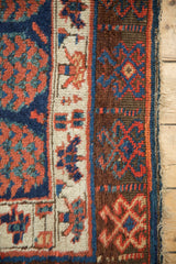Textured chocolate, cobalt, and copper geometric guls on antique Kurdish rug border with natural fringe.