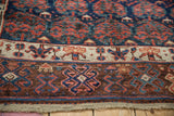 Antique Kurdish rug border, geometric guls, stylized boteh, cobalt, copper, ivory, visible knot heads.