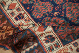 Textured pile of late 19th century Kurdish rug, with cobalt blue, copper boteh, and geometric blossoms.