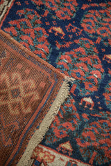 Hand-knotted foundation revealing knot heads and vibrant pile on an antique Kurdish rug.