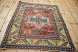 Antique Kazak rug corner detail, highlighting serrated leaf border on unusual yellow ground.