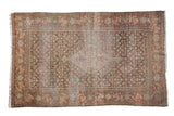 Antique Persian Senneh rug with diamond medallion, floral field, time-softened cochineal and silver tones.